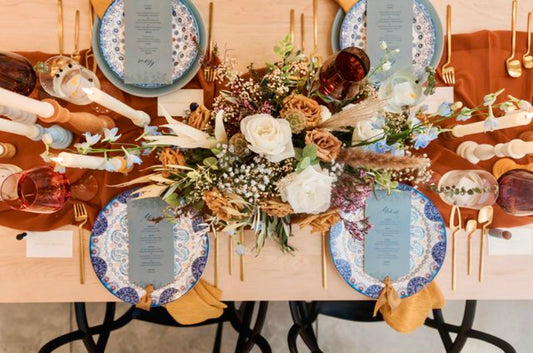 Using this rust-colored runner to provide the contrast needed to make the robin's egg blue and mustard colors pop on this naturally finished table is a fun spin on traditional autumn palettes.  Tabletop decor provided by @curatedthecollection.